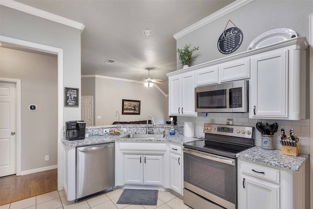 kitchen with sink, white cabinetry, stainless steel appliances, crown molding, and ceiling fan