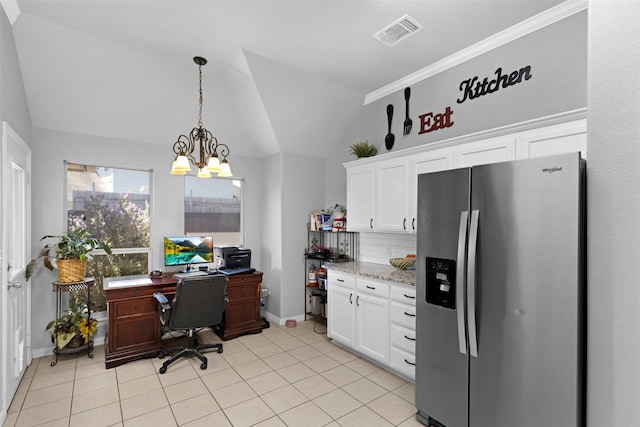 interior space with stainless steel fridge, decorative backsplash, vaulted ceiling, white cabinets, and a chandelier