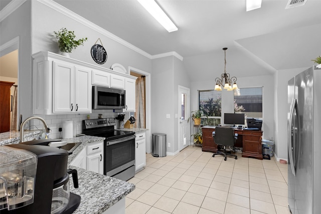 kitchen with a notable chandelier, white cabinets, vaulted ceiling, and appliances with stainless steel finishes