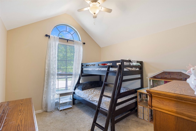 bedroom with lofted ceiling, ceiling fan, and light colored carpet