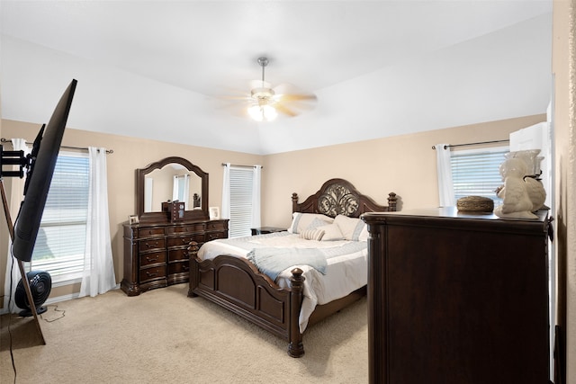 carpeted bedroom featuring vaulted ceiling, ceiling fan, and multiple windows