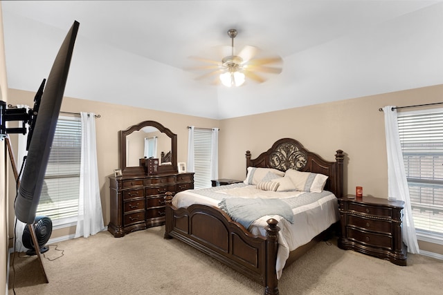 bedroom with multiple windows, light colored carpet, and ceiling fan