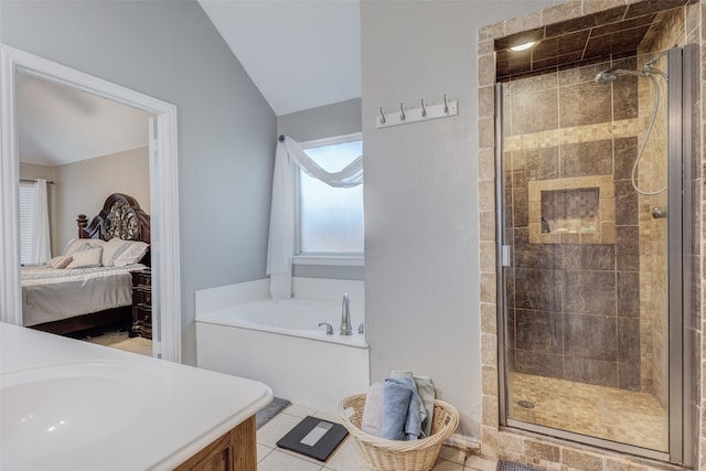 bathroom featuring tile patterned flooring, vaulted ceiling, vanity, and plus walk in shower