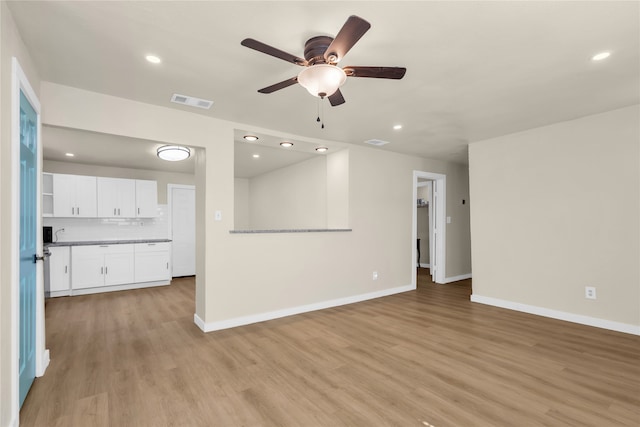 unfurnished living room featuring light hardwood / wood-style flooring and ceiling fan