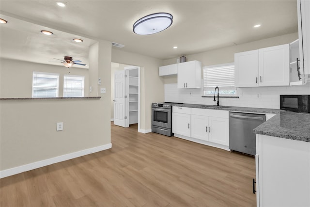 kitchen featuring white cabinets, ceiling fan, appliances with stainless steel finishes, and plenty of natural light