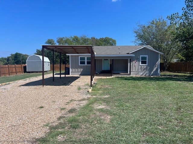 view of front of house with a shed and a front yard