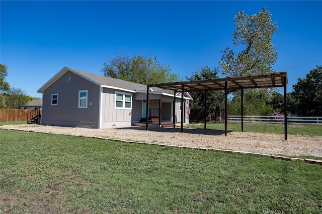 rear view of house featuring a lawn