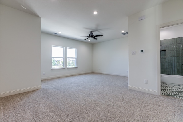 unfurnished room with ceiling fan and light colored carpet