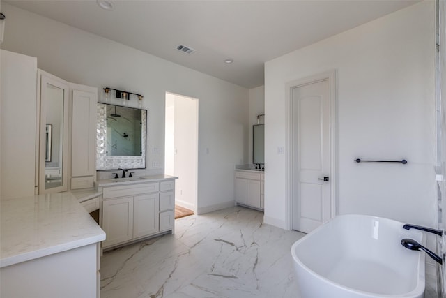 1120 Stonebridge Pass, Gunter, TX 75058 - full bathroom featuring a freestanding bath, a stall shower, two vanities, marble finish flooring, and recessed lighting
