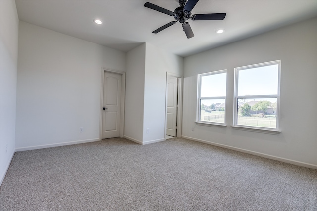 unfurnished bedroom featuring ceiling fan and light carpet