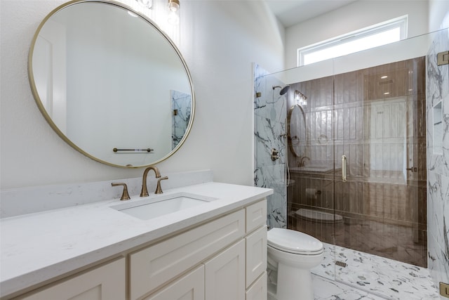 bathroom with vanity, a shower with shower door, and toilet