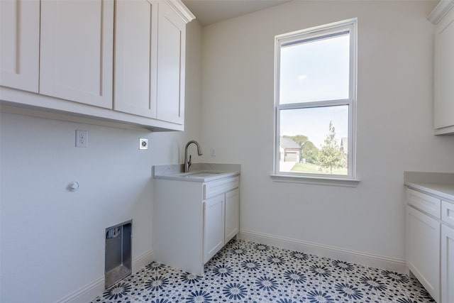 1120 Stonebridge Pass, Gunter, TX 75058 - laundry room featuring cabinet space, electric dryer hookup, and baseboards