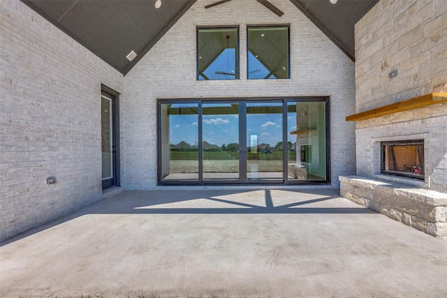 1120 Stonebridge Pass, Gunter, TX 75058 - doorway to property with an outdoor stone fireplace, a patio area, and brick siding