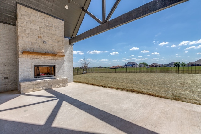 view of patio / terrace featuring an outdoor stone fireplace