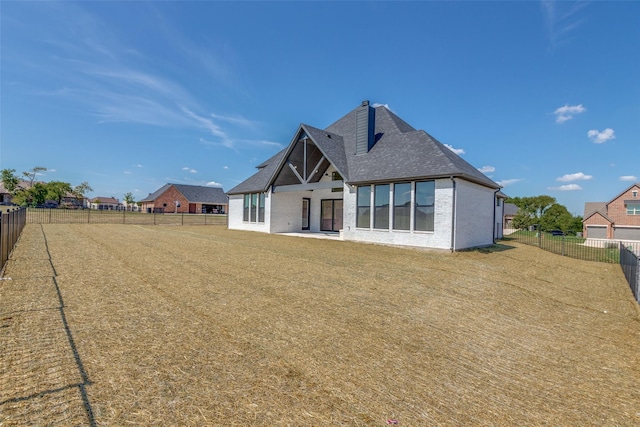 1120 Stonebridge Pass, Gunter, TX 75058 - rear view of house with a fenced backyard, brick siding, a chimney, and a shingled roof