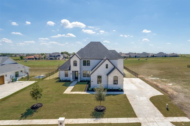 french provincial home featuring a front yard