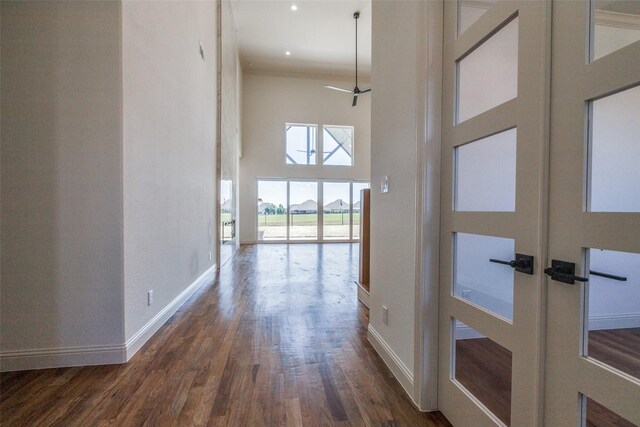 1120 Stonebridge Pass, Gunter, TX 75058 - hallway with a towering ceiling, baseboards, wood finished floors, ornamental molding, and french doors