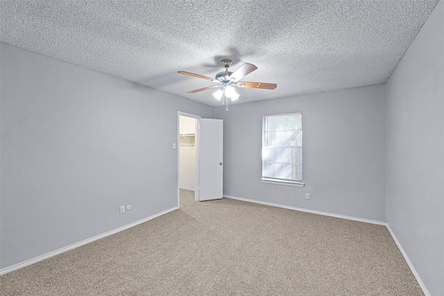 empty room with carpet, a textured ceiling, and ceiling fan