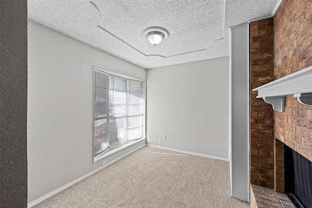 empty room with brick wall, a textured ceiling, and carpet floors