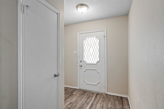 entrance foyer with a textured ceiling and hardwood / wood-style floors