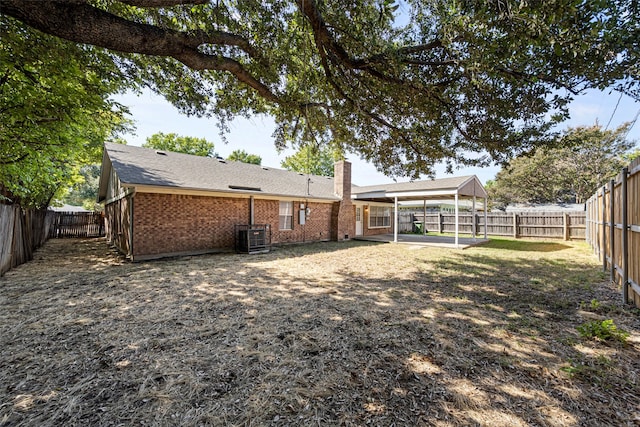 back of property featuring central AC