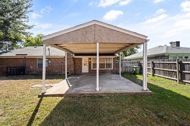 back of house featuring a patio and a lawn