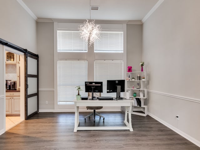 office space with a chandelier, crown molding, dark wood-type flooring, and a barn door