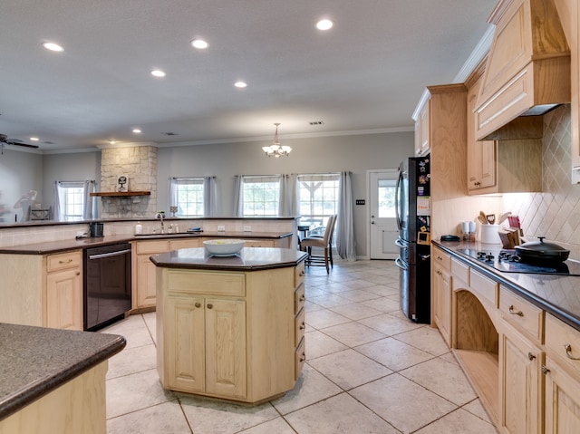 kitchen with black appliances, kitchen peninsula, light brown cabinetry, and a notable chandelier