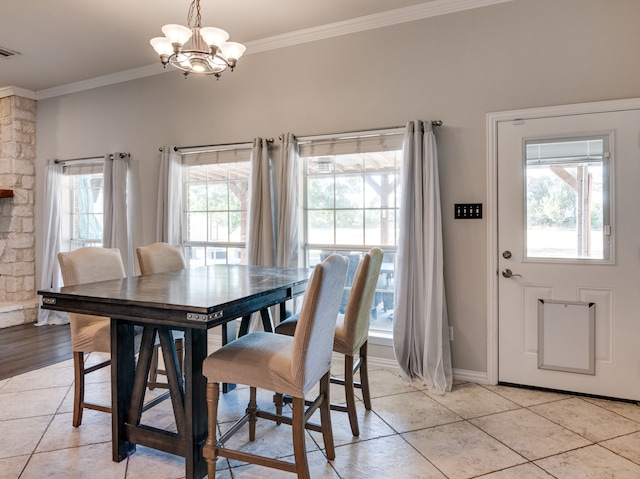 dining space featuring light tile patterned floors, crown molding, a chandelier, and a healthy amount of sunlight