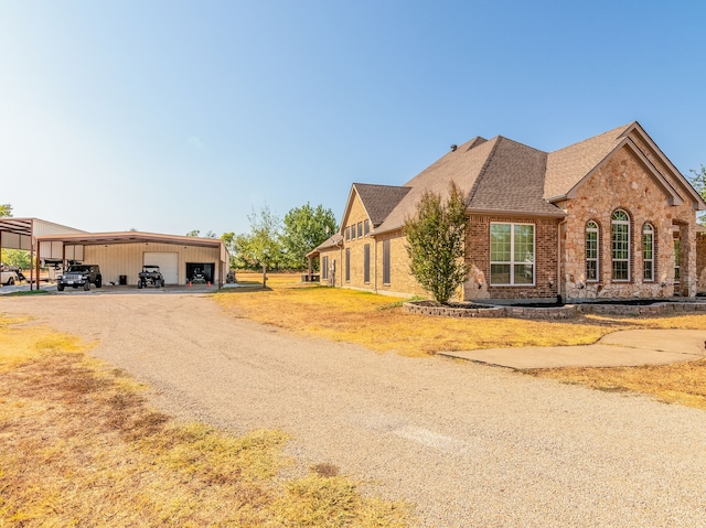 view of front facade featuring a garage, a front lawn, and a carport