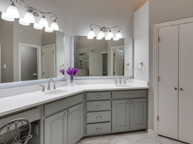 bathroom featuring a shower with door and vanity