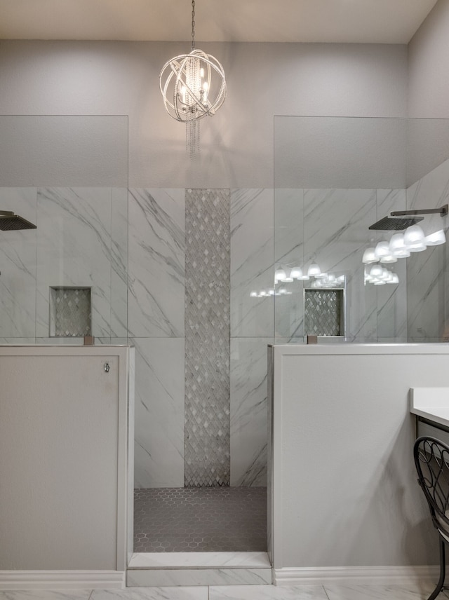 bathroom with a tile shower, a chandelier, and vanity