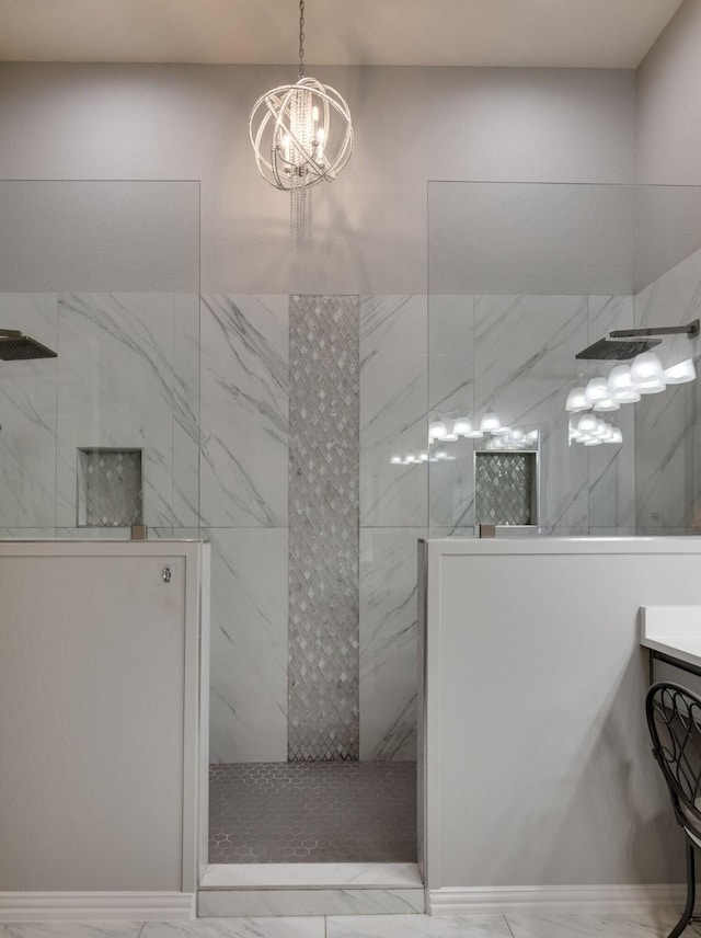 bathroom featuring marble finish floor, vanity, a marble finish shower, and an inviting chandelier