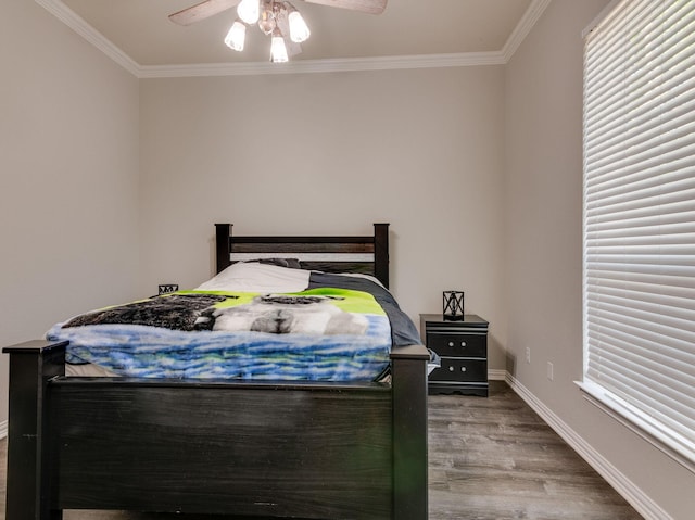 bedroom with ornamental molding, ceiling fan, baseboards, and wood finished floors