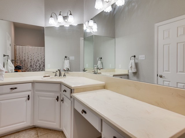 bathroom with tile patterned flooring, walk in shower, and vanity