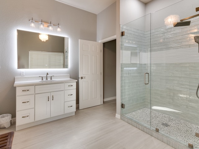 bathroom featuring vanity, hardwood / wood-style floors, and a shower with door