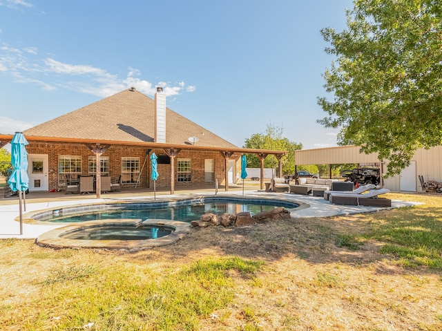 view of pool featuring outdoor lounge area, an in ground hot tub, and a patio area