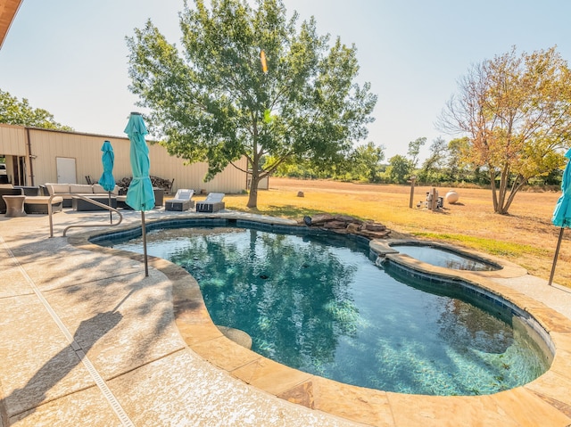 view of pool featuring a lawn, an in ground hot tub, a patio area, and outdoor lounge area