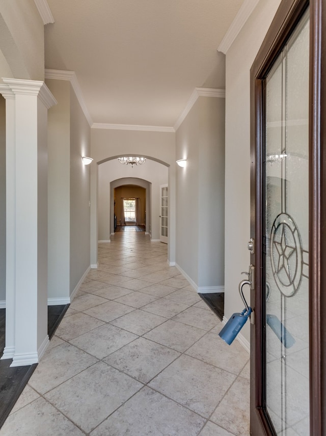 hallway featuring ornamental molding and ornate columns