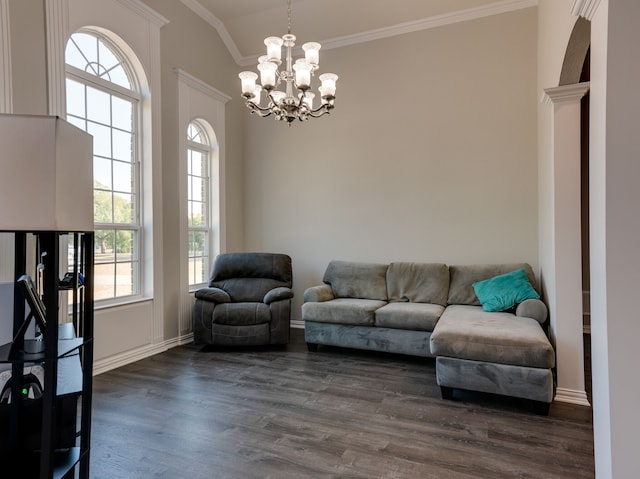 living room featuring ornamental molding, an inviting chandelier, plenty of natural light, and dark wood-type flooring