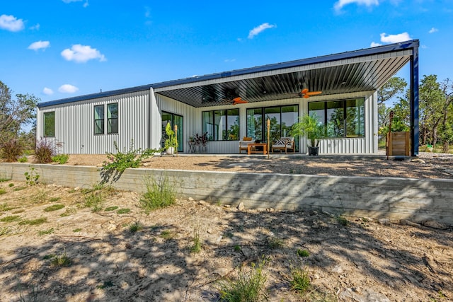 back of property with ceiling fan