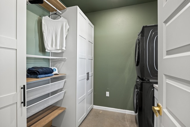 spacious closet featuring stacked washer / drying machine and light colored carpet