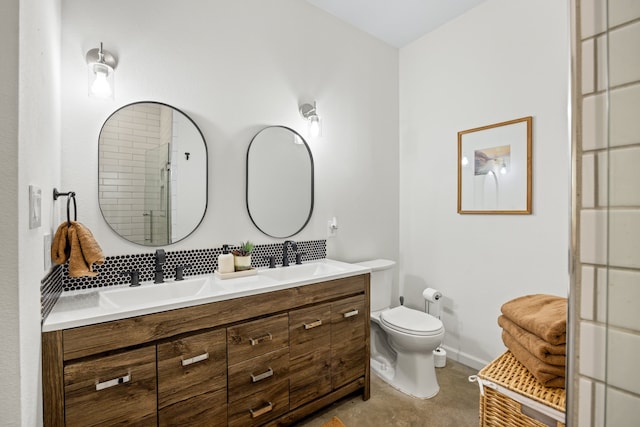 bathroom featuring vanity, a shower with door, and toilet