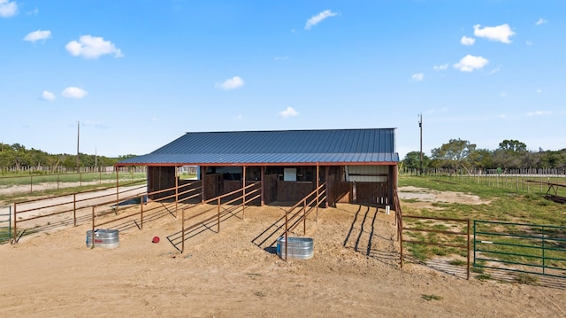 view of horse barn with a rural view