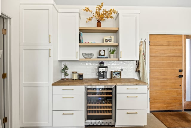 bar with white cabinets, wine cooler, tasteful backsplash, and butcher block counters