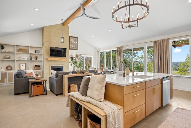 kitchen with sink, a fireplace, beam ceiling, and a wealth of natural light