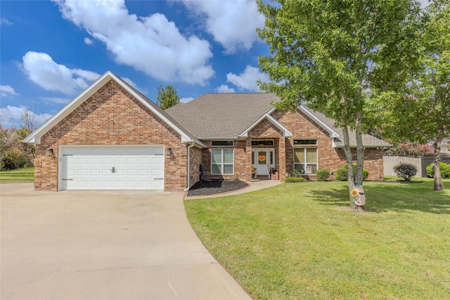 view of front of property with a front yard and a garage