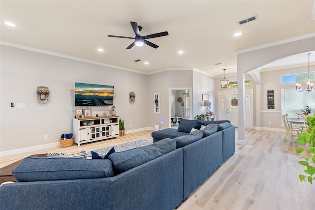 living room with ceiling fan with notable chandelier, crown molding, and light hardwood / wood-style flooring