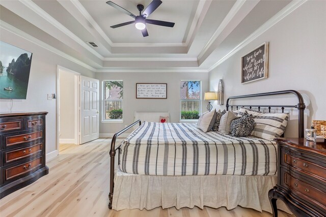 bedroom with multiple windows, crown molding, light hardwood / wood-style floors, and ceiling fan