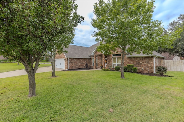 view of front of house with a front yard and a garage